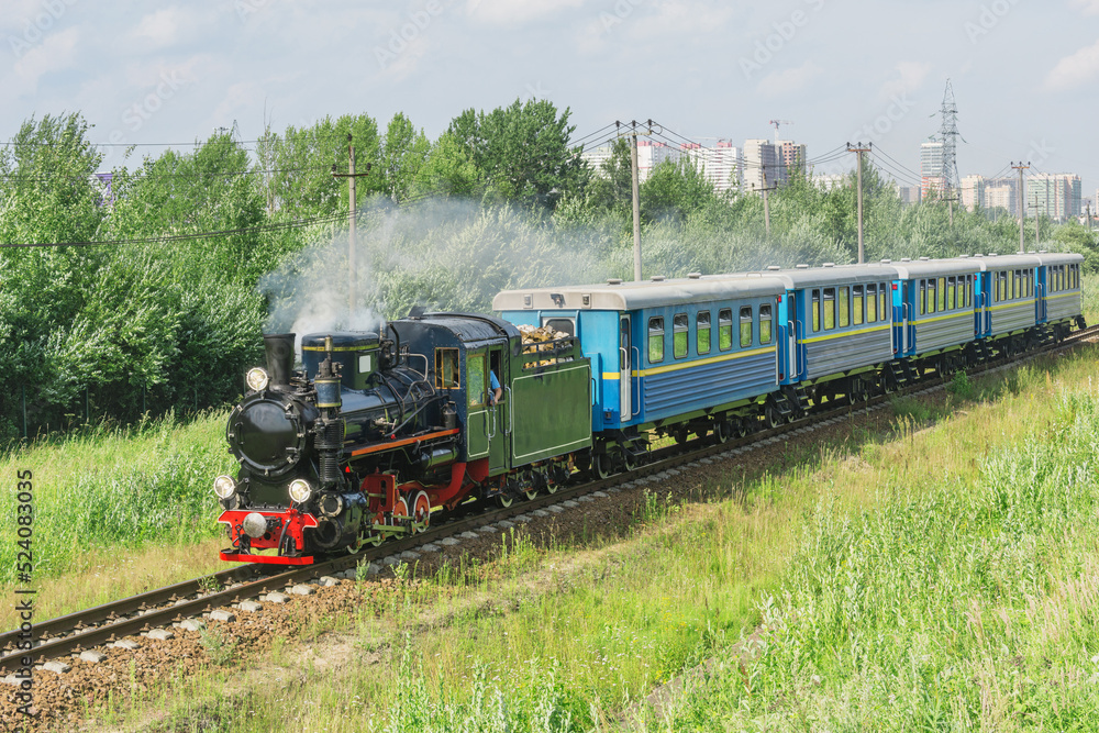 Passenger steam train of Children's railway moves to the station. Saint Petersburg.
