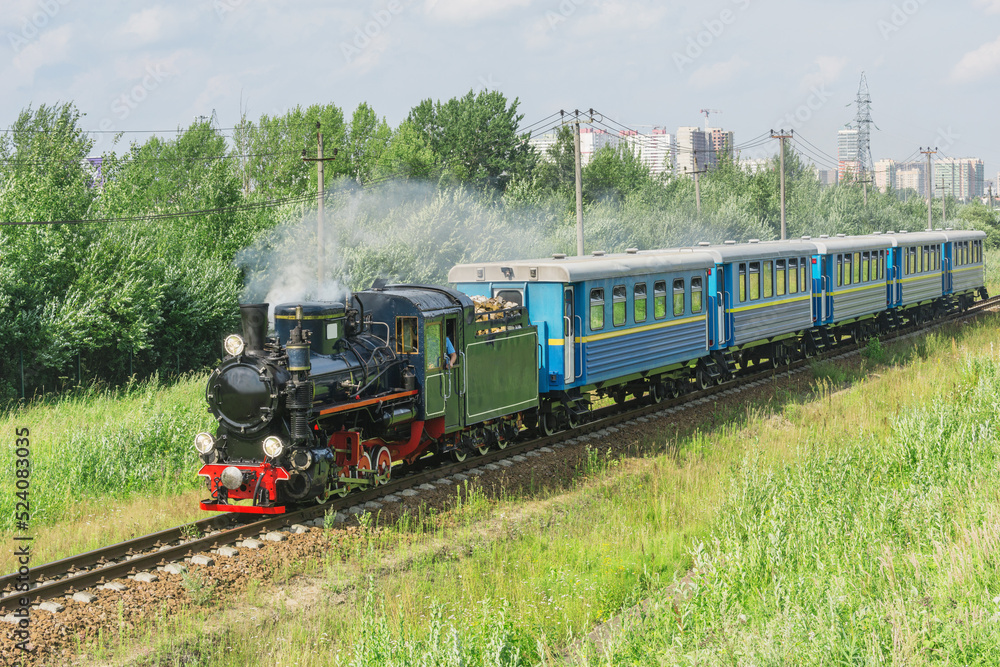 Passenger steam train of Children's railway moves to the station. Saint Petersburg. Passenger steam train of Children's railway moves to the station. Saint Petersburg.