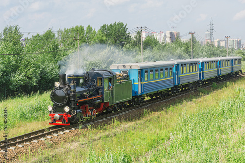 Passenger steam train of Children's railway moves to the station. Saint Petersburg.