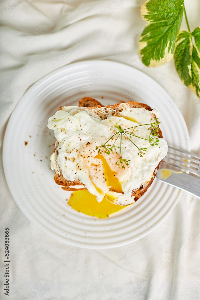 Breakfast on white bed sheets, good morning, toast with poached eggs, coffee, flowers, Hotel room early morning, honeymoon