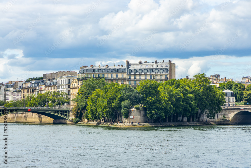 Square Barye and Ile Saint-Louis island seen from a Bateau Mouche tour boat cruising on the Seine river in Paris, France