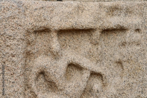 Bas relief rock cut sculptures of gods, people and animals are carved prominently in the monolithic cave temples at Mahabalipuram, Tamil nadu, India photo