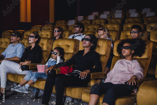 Group of Caucasian white and African audiences enjoying a 3D movie.