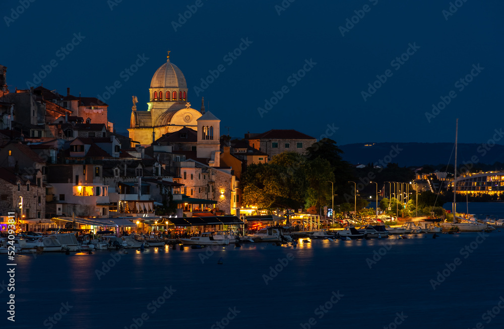 Evening Sibenik city in Croatia, night city lights reflection, cityscape