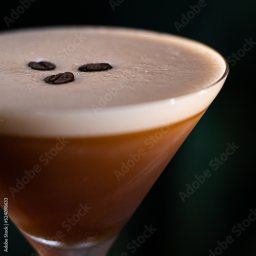 espresso martini cocktail with foam and three coffee beans