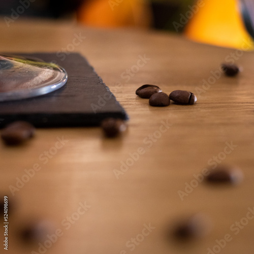 Wood table with coffee beans and glass stem