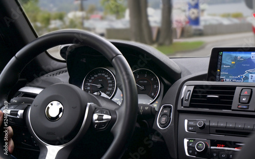 Interior view of car, Luxury car steering wheel and clean dashboard with display or monitor screen. © Phot