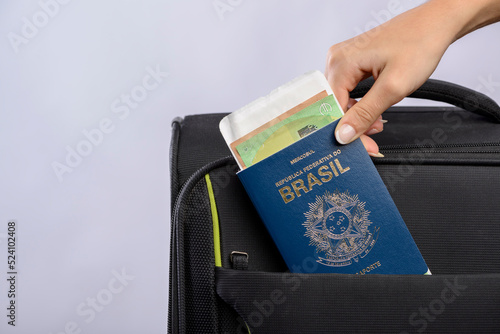 Brazilian passport being placed in the suitcase.