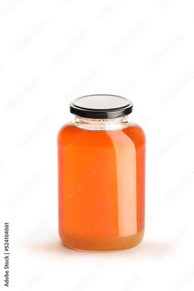 Studio shot of a jar of honey with a black lid Studio shot of a jar of honey with a black lid