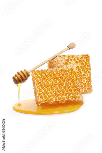 Pieces of a honeycomb with a honey dipper