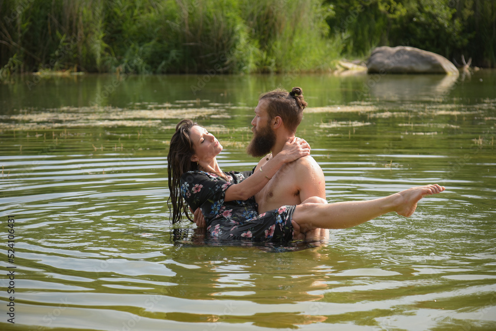 caucasian couple in love having a bath in a lake caucasian couple in love having a bath in a lake