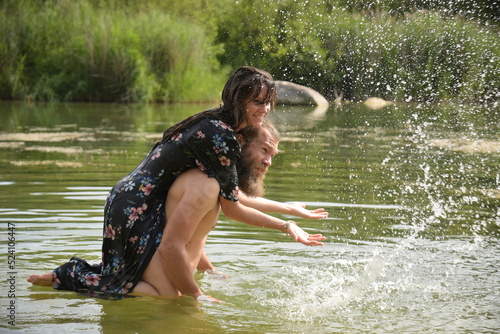 Fototapeta Naklejka Na Ścianę i Meble -  caucasian couple in love having a bath in a lake