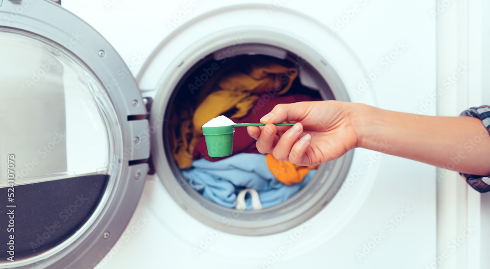 Female hand holds a cap with washing powder. Female hand holds a cap with washing powder.