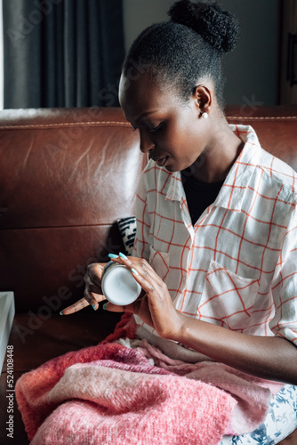 Woman getting painkiller medication at home photo