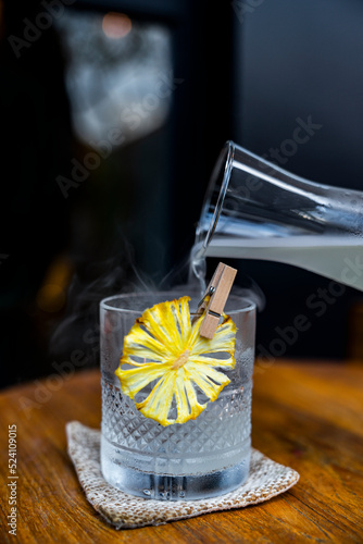 Alcoholic drink garnished with dried pineapple