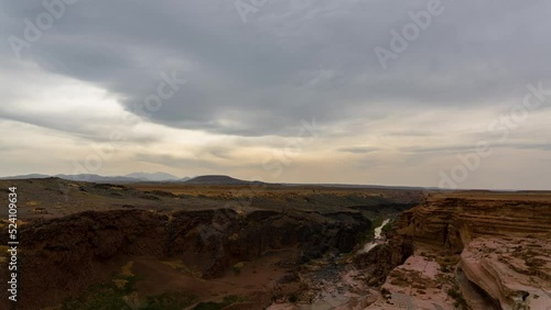 Time lapse of stormy sky over volcanic canyon at Grand Falls in Arizona, USA