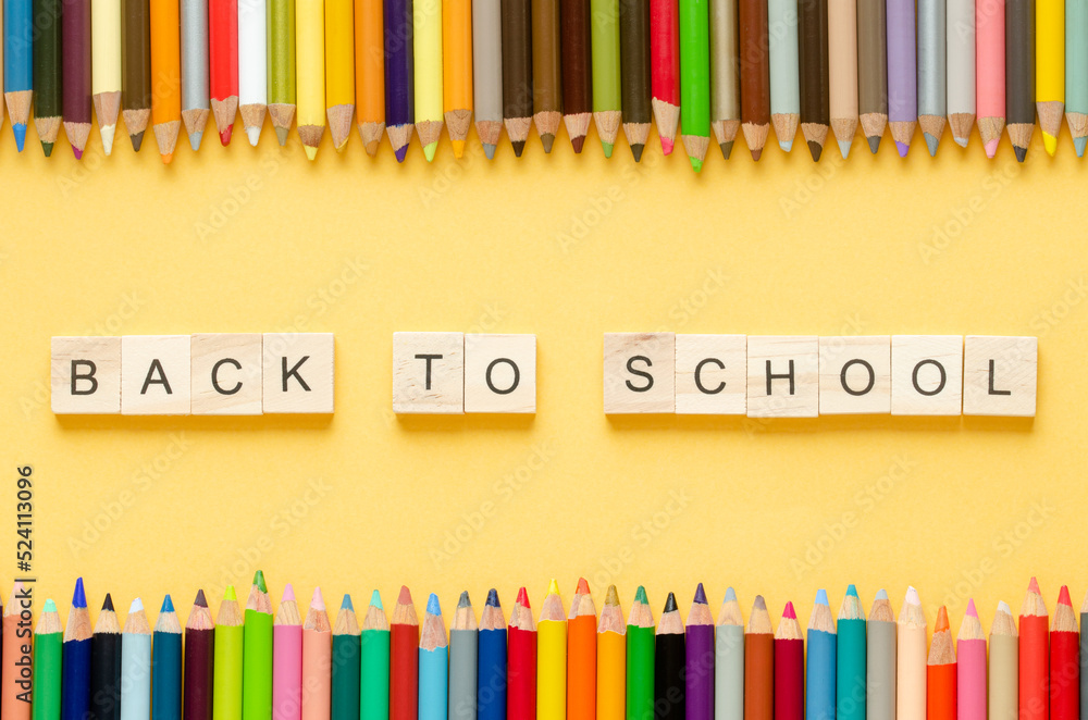 Obraz premium Back to class. Coloured pencils and letters BACK TO SCHOOL on yellow background. Copy space.