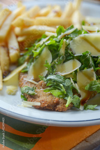 Close up of breaded meat with salad