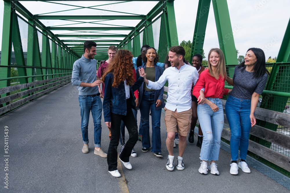 Obraz premium Group of young people from different cultures having a fun time outdoors