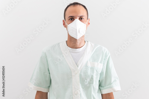 male doctor in white protective respirator close-up, concept of biohazard, emergency, SARS virus pandemic, COVID-19, coronavirus