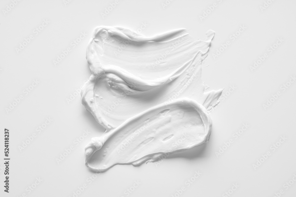 White smear of cosmetic cream or acrylic paint isolated on white background. White smear of cosmetic cream or acrylic paint isolated on white background.