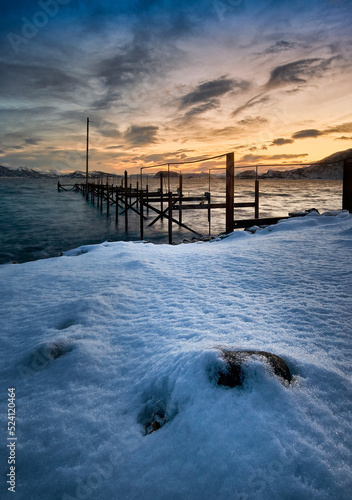 Run down jetty with gorgeous winter sunset on God  y  Sunnm  re  M  re og Romsdal  Norway.