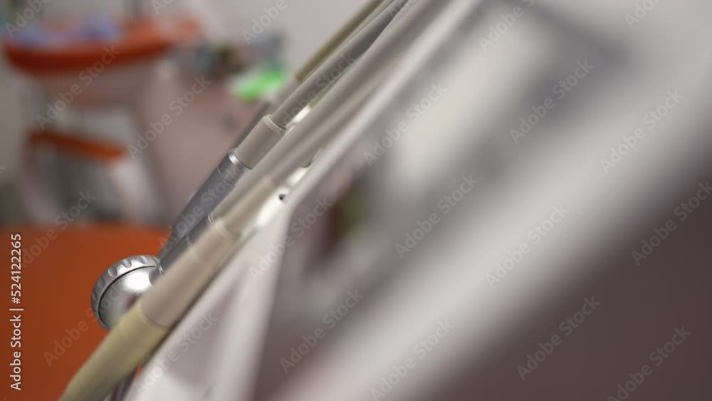 Side view close-up medical tools in dental office in hospital indoors. Professional equipment for dental health in medical clinic with no people Side view close-up medical tools in dental office in hospital indoors. Professional equipment for dental health in medical clinic with no people