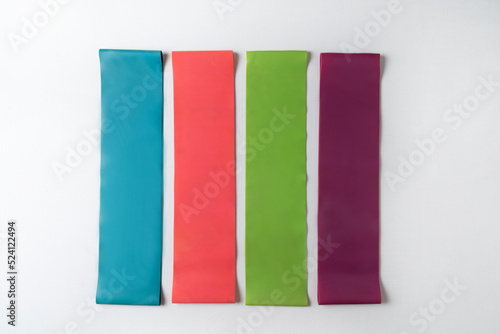 Free Download Colorful fitness bands lying on a white background - GFXLoad