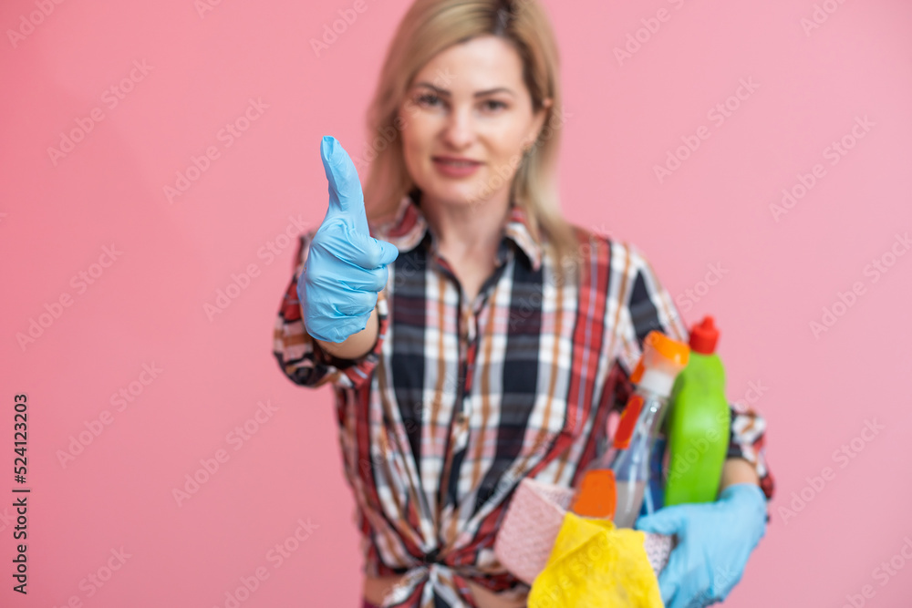 Beautiful blonde woman holding basket and detergent bottle. Beautiful blonde woman holding basket and detergent bottle.