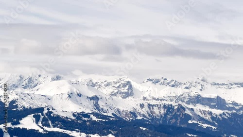 High mountain Alps peaks covered with clouds panorama photo