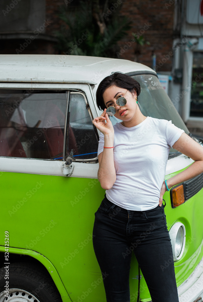 young greaser girl with short hair, posing with a fifties 