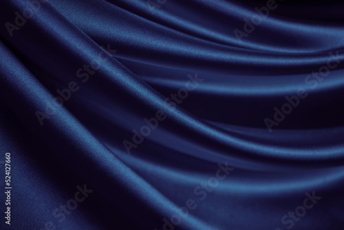 Black blue silk satin. Dark elegant background with space for design. Soft folds. Wavy. Shiny smooth fabric. Luxurious. Valentine, 14.02, Christmas, New year, festive.