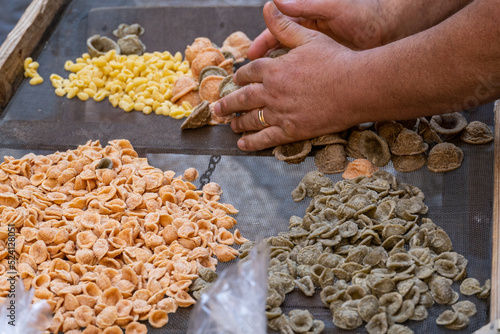 Typical italian pasta orecchiette of different color and freshly handmade in Bari Puglia Italy photo