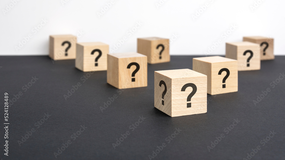 front view on many wood cubes with question marks. many question arising concept front view on many wood cubes with question marks. many question arising concept