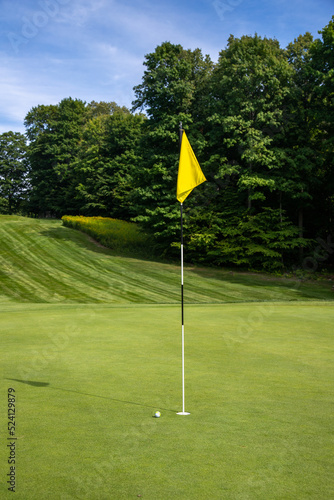 Golf ball next to the hole with flag, putt, golf game, green