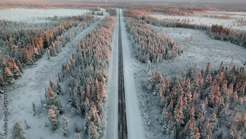 Aerial shot of a road going through a forest in Jamtland Sweden in winter
