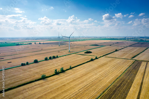 Wiejski krajobraz z wiatrakami. Energia odnawialna w Polsce. Prąd z wiatru. Elektrownia wiatrowa. photo