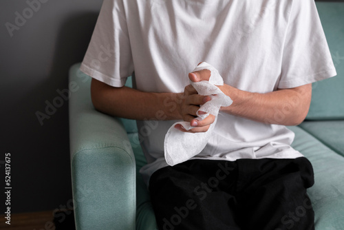 wiping hands with wet wipe, personal hygiene concept