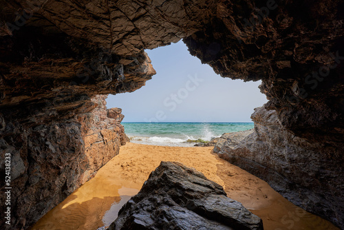 Cave by the sea and girl taking a bath. Calblanque Regional Park in Murcia photo