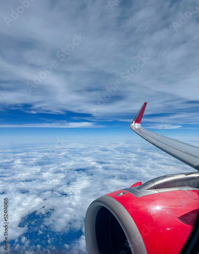 Beautiful View of Sky Clouds and Horizon from Jet Airplane Wing and Engine