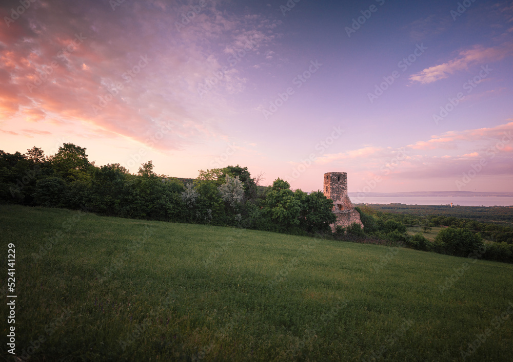 Sunset over the medieval ruins of a temple at lake Balaton, Hungary
