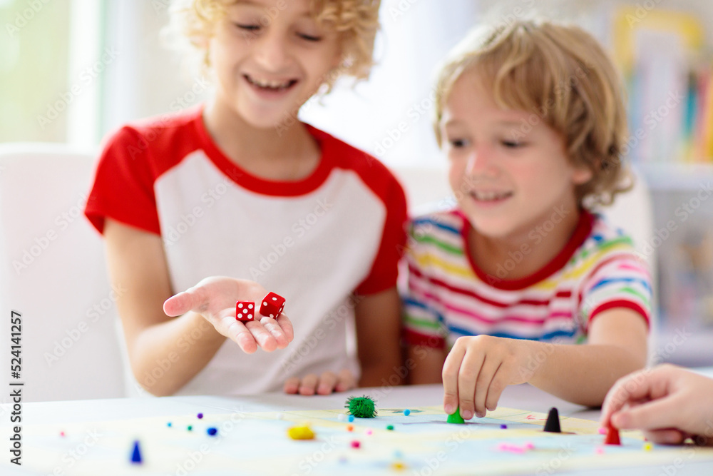 Family playing board game. Kids play.