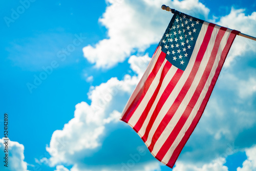 United States flag with blue sky in the background.