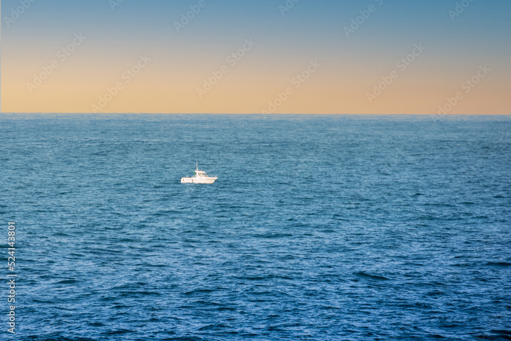 small boat in the middle of the sea on a sunny day as a marine
