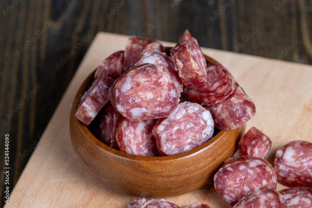 Cut the finished sausage into pieces on a cutting board Cut the finished sausage into pieces on a cutting board