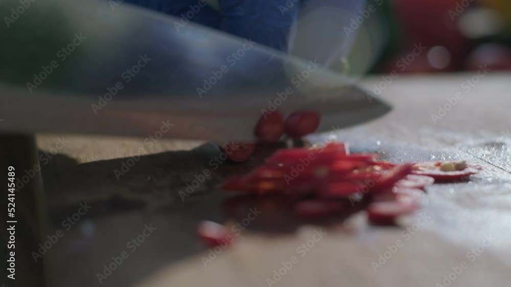 Red hot chili pepper cut by the knife on the board Red hot chili pepper cut by the knife on the board