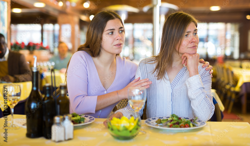 Quarrel of two friends during dinner in a restaurant