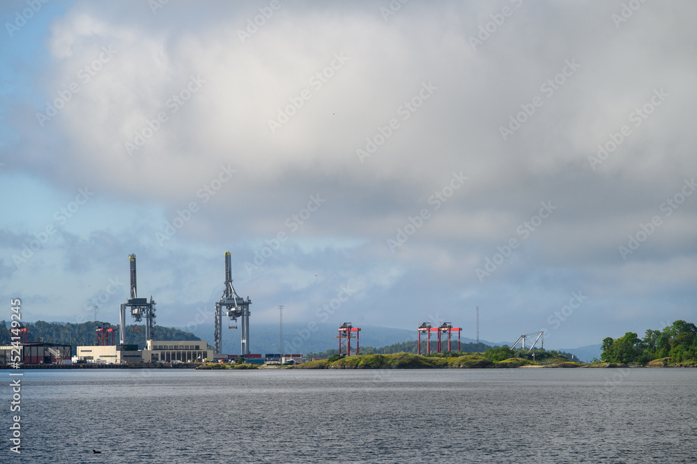 Fototapeta premium Oslo industrial port with cranes on the skyline, shipping and transportation background 