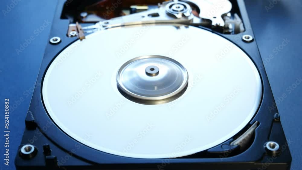 Disassembled hard drive disk, close up. How hard disk works, start and stop, the magnetic disk is spinning from the inside. Broken tightness of the hard drive. HDD repair, Data Recovery. Disassembled hard drive disk, close up. How hard disk works, start and stop, the magnetic disk is spinning from the inside. Broken tightness of the hard drive. HDD repair, Data Recovery.