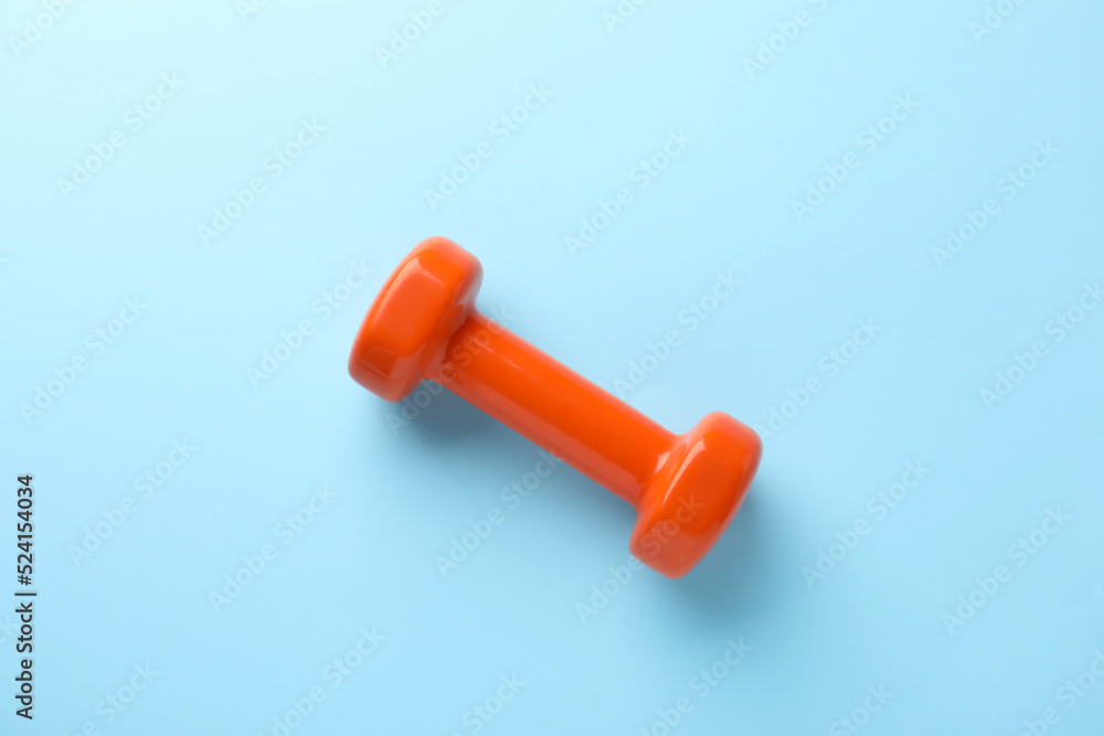 Stylish dumbbell on light blue background, top view Stylish dumbbell on light blue background, top view